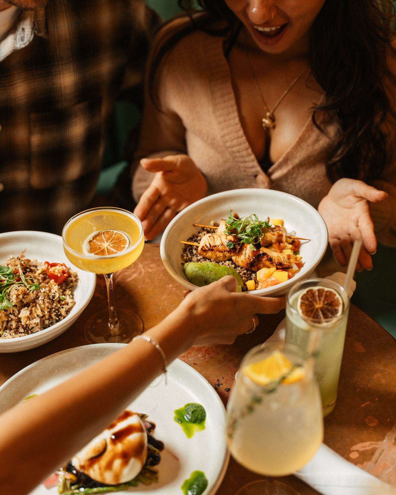 A table of brunch dishes and citrus cocktails at Dear Maud